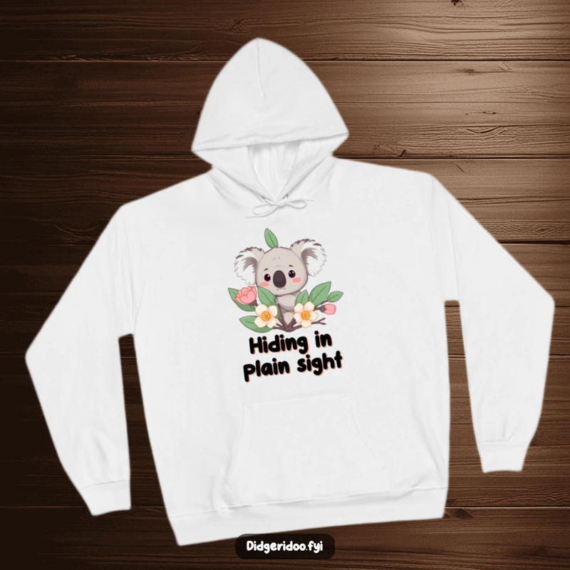 Funny Hoodie: A curious koala peeks from behind a stylized eucalyptus bloom, a warm and humorous apparel choice.