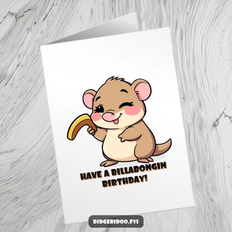 Funny Free Printable Birthday Card of a happy platypus winking while holding a small boomerang, ready for birthday adventures.
